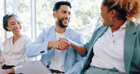 Recruitment, handshake and business people networking in job interview waiting room, happy and friendly. We are hiring, job opportunity and hand shaking by man and woman relaxing in line at startup