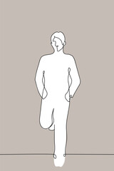 man stands leaning against the wall with his back and feet with his hands in his pockets