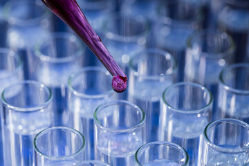Pipette dropping fluid into test tube