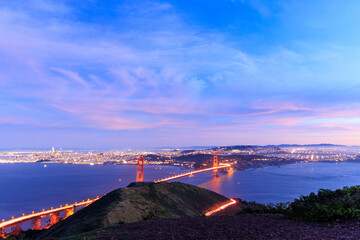Car lights on Golden Gate Bridge by San Francisco and Pink Clouds at Blue Hour