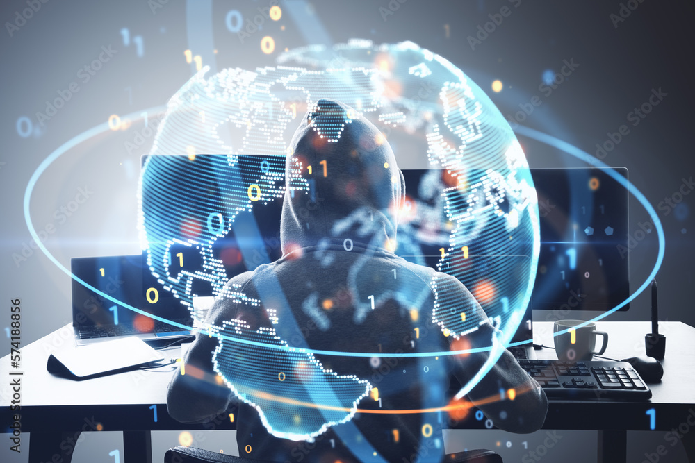 Aufkleber Hacker at desktop using computers with glowing globe hologram. Global hacking, crime and phishing concept. Double exposure.
