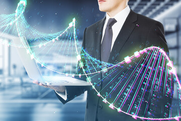 Close up of businessman hands using laptop with glowing binary code DNA helix on blurry office interior background. Human genome and innovative technologies concept. Double exposure.