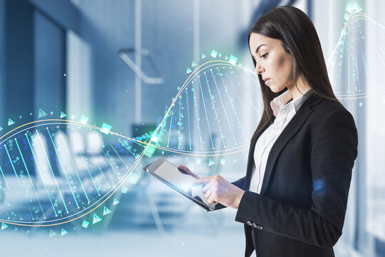 Young european businesswoman using digital tablet device with glowing binary code DNA helix on blurry office interior background. Human genome and innovative technologies concept. Double exposure.