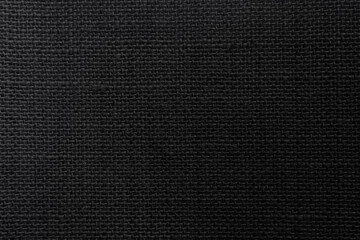 Black hemp rope texture background. Haircloth wale black dark cloth wallpaper. Rustic sackcloth canvas fabric texture in natural.

