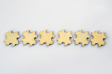 A mock-up of six blank wooden puzzles on a white background for your text or design. For brainstorming.