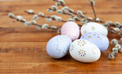 easter eggs and willow branches close-up on a wooden surface