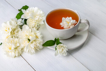 Jasmine tea in a cup on a wooden background. Copy space