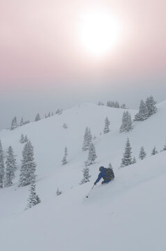 A man backcountry skiing on an overcast day outside Silverton, Colorado.