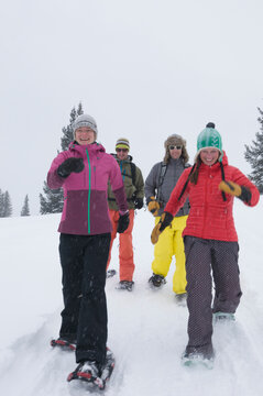 A group of adults snowshoeing on a snowy day near Molas Pass, Silverton, Colorado.