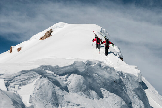 Two male ski patrollers working at the Crested Butte Ski Resort, Crested Butte, Colorado.