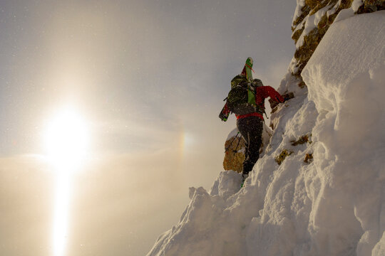 Female skier climbing steep slope above Ophir Pass, San Juan National Forest, Silverton, Colorado, USA