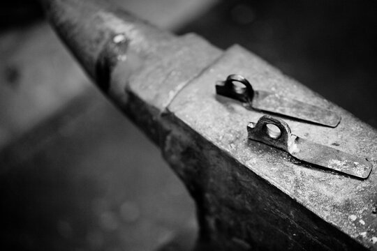Two pitons sit on top of a well-used anvil in the Tin Shed at Patagonia headquarters in Ventura, California.
