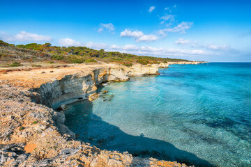 Picturesque seascape with white rocky cliffs, sea bay, islets and faraglioni near by beach Spiaggia...