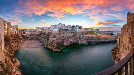 Stunning sunset at Cala Paura gulf with Bastione di Santo Stefano and Lama Monachile beach in background.