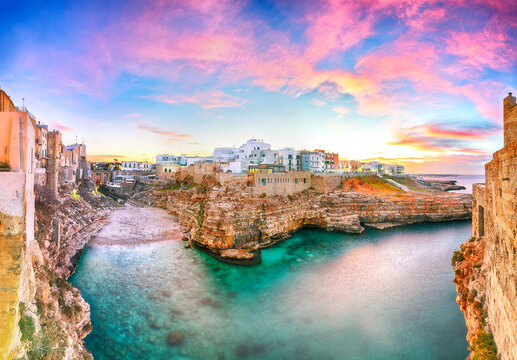 Stunning sunset at Cala Paura gulf with Bastione di Santo Stefano and Lama Monachile beach in background.