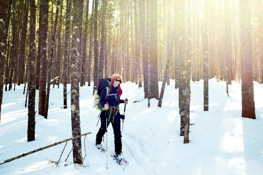 A young women snowshoeing through Baxter State Park.