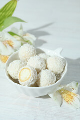 Concept of tasty sweets on white wooden table, coconut candies