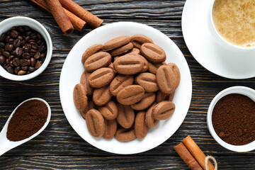 Concept of tasty snack for hot drink - cookies in the shape of coffee seeds
