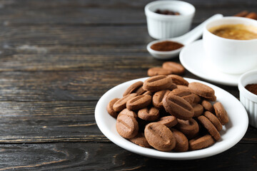 Concept of tasty snack for hot drink - cookies in the shape of coffee seeds