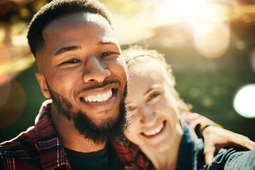 Couple, love selfie and portrait smile at park outdoors, enjoying fun time and bonding together. Diversity, romance and face of black man and woman taking pictures for happy memory or social media.