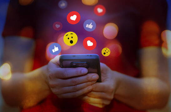  Social media, social network concept. Hands of woman post button love, heart, chat, emoji icon, chat typing on mobile phone