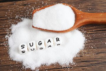 SUGAR, sweet granulated sugar with text, diabetes prevention, diet and weight loss for good health.
