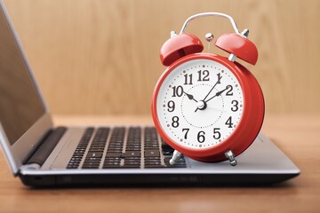 laptop computer and retro alarm clock