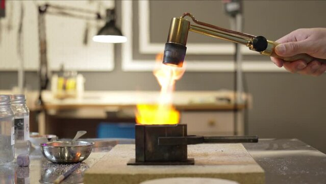 Production and making manufacturing, factory, cast craft design, process precious gold jewelry, jewels, ring jeweler, goldsmith in workshop. Manufacturing Wedding Ring.