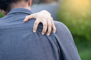 
man holding hands on shoulder have shoulder pain