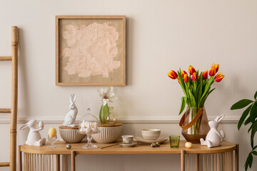 Fototapeta na wymiar Interior design of easter living room interior with mock up poster frame, glass vase with tulips, wooden sideboard, easter bunny sculpture, bowl, ladder, and personal accessories. Home decor. Template