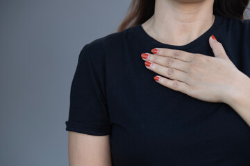 
Close-up shot of a woman holding her breasts woman having a heart attack chest pain health care concept