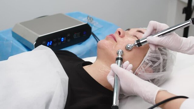 Cosmetology microcurrent treatment of facial skin. Prevention of premature aging of the skin. 4k video