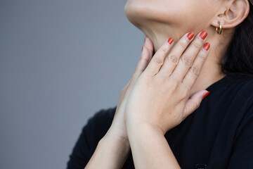 Beautiful young woman touching her sick neck with hands she has neck pain
 Sore throat Difficulty swallowing
