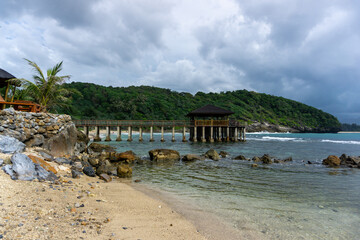  tropical beach in Banda Aceh, Indonesia. Eky Momong Beach. Resataurant at the beach. Concrete bridge leading to water villa or bungalow.