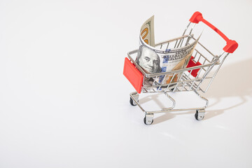 american banknotes of 100 dollars in a basket on a white background