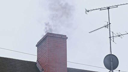 Dark Toxic Smoke Coming Out of House Roof Chimney Polluting Air and Creating Smog in the City