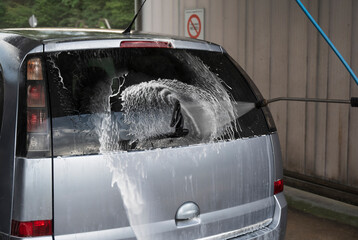 Manual car wash with pressurized water in car wash outdoors. - 574223016