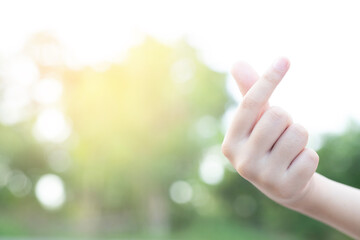 Small heart hands isolated on nature background. This image can be used for the world of love or valentine concept.