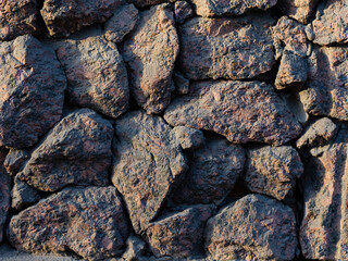 Rough granite stones. The texture of the stone wall. Great for background and design.