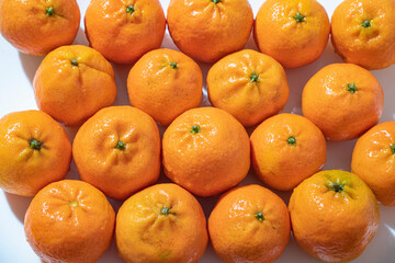 tangerine on a white background. How to choose, store and how much you can eat so as not to harm the body.	