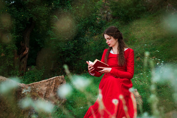 Vintage portrait of a beautiful noble lady in a red dress with a book in the garden 4