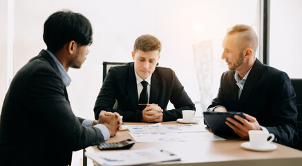 Business team discuss at meeting room. working together with laptop ,tablet and smart phone on desk Financial accountant , planner , meeting , introduction concept. At office.