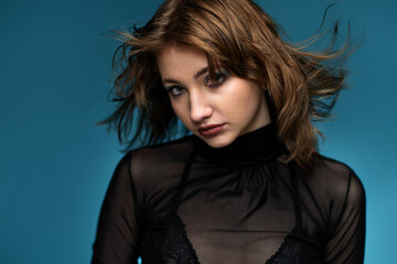 Fototapeta premium young woman with stylish hairstyle posing in black leather jacket