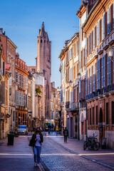 View on the Rue du Taur and Notre Dame du Taur church and typical facades of Toulouse, in the south...