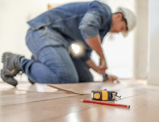 Construction worker tape measure, wood carpenter and home floor renovation of a builder. Working,...