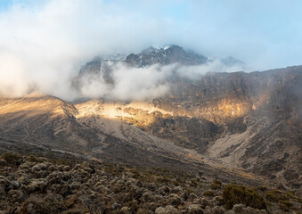 Awe-Inspiring Snowy Mountain Peak Rising Above the Clouds
