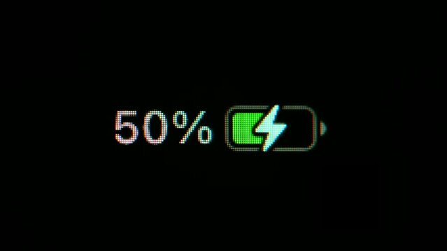 Time Lapse: Your smartphone battery charges from zero to 100%. Close the macro shot of the battery level indicator on your smartphone that is charging over time.