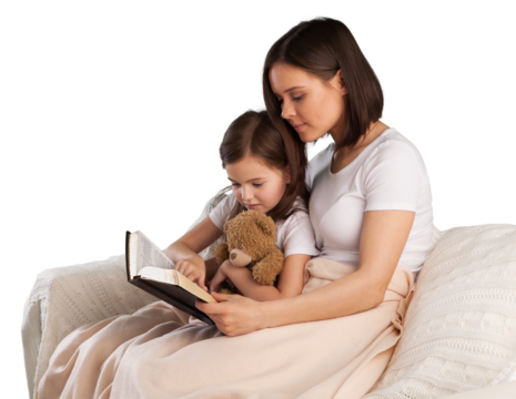 Young mother and child girl reading a book in bed before going to sleep