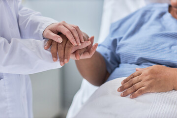 Close up of nurse holding hands with female patient in hospital room with care and support, copy space