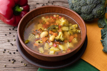 vegetable soup with vegetables and cauliflower in a clay plate